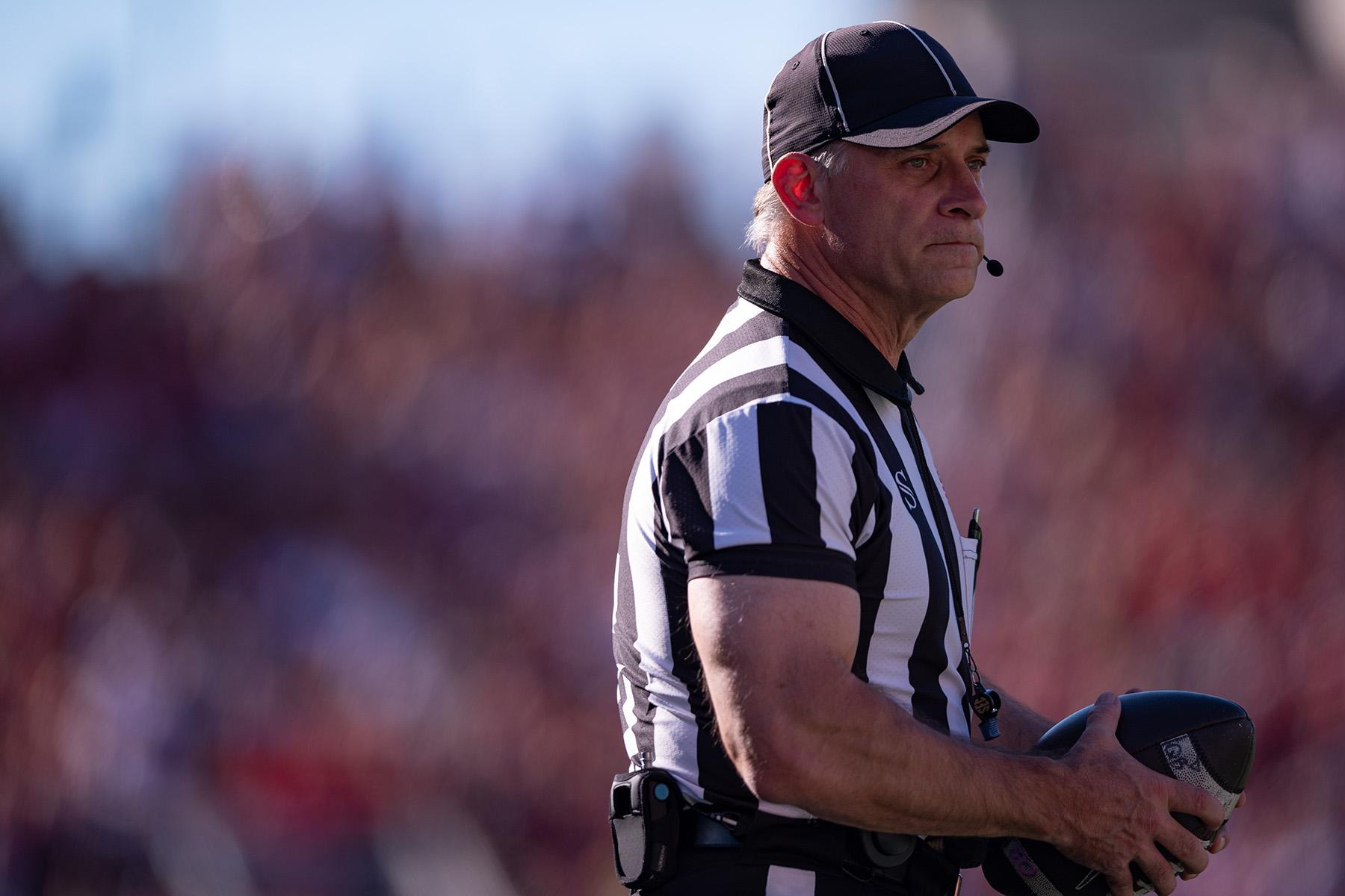 Chris Garner holds a football during a college football game.