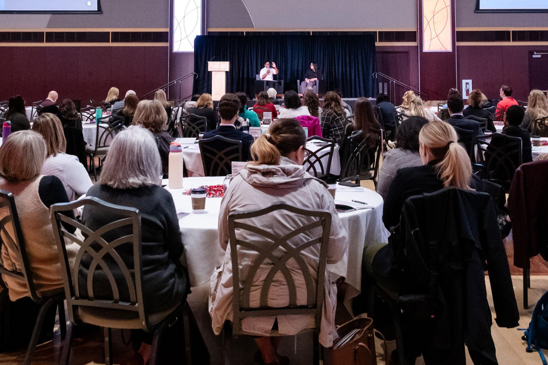 People seated around round tables in the Ohio Union ballroom.