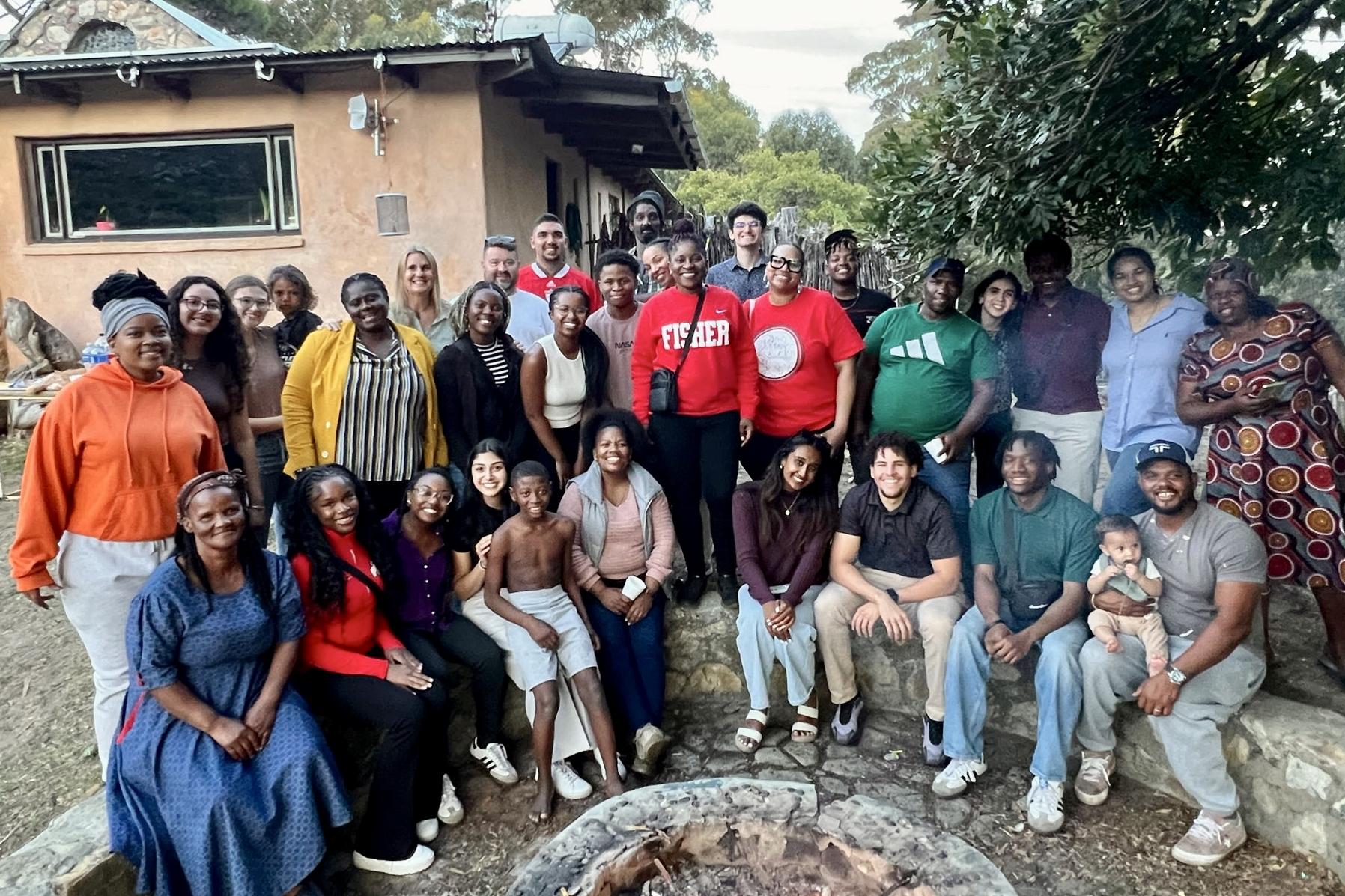 Ohio State students in different clothes pose for a group photo outside in South Africa