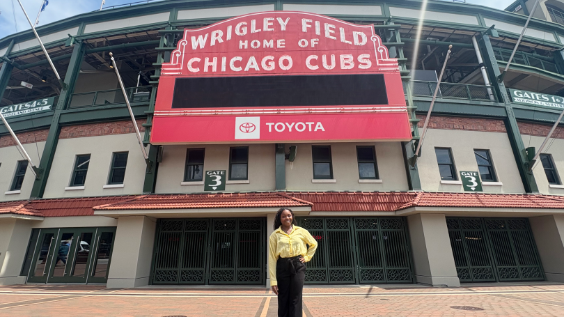 Elisabeth Christina Kearney stands outside Wrigley Field under the the baseball stadium's iconic red marquee