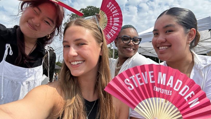 Group of four women, including Olivia Tyka, holding Steve Madden fans