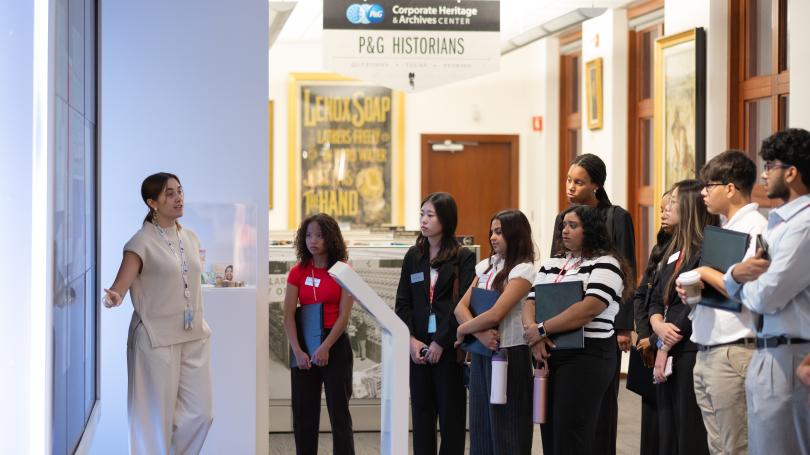 Group of students listening to P&G staff member explain exhibit at the Heritage Center