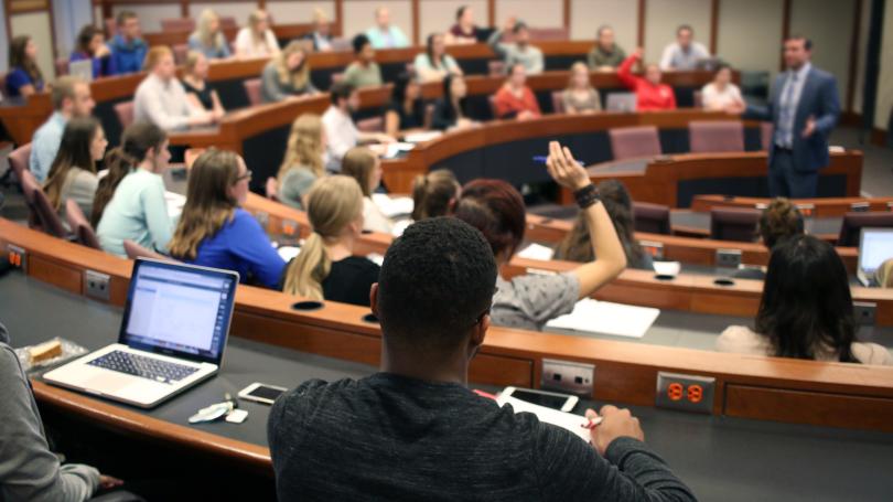 Back of classroom view of students listening to lecture