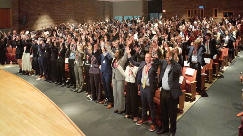 Two hundred audience members in auditorium spelling out O-H-I-O with their arms