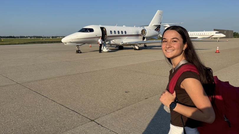 Lexy Payne with backpack walking towards NetJets plane