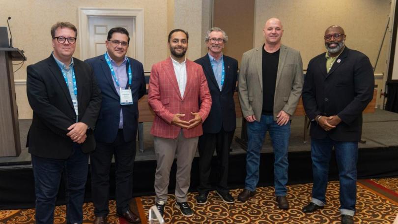 Six faculty members from Ohio State pose for a group photo at the 2026 CSCMP awards event, standing together in business attire in front of a conference stage.