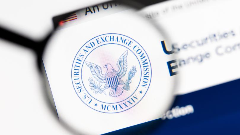 Magnifying glass hovering over the Securities and Exchange Commission logo