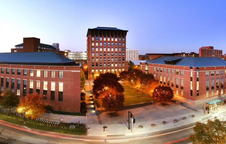 Panoramic photo of Fisher campus lit up at night