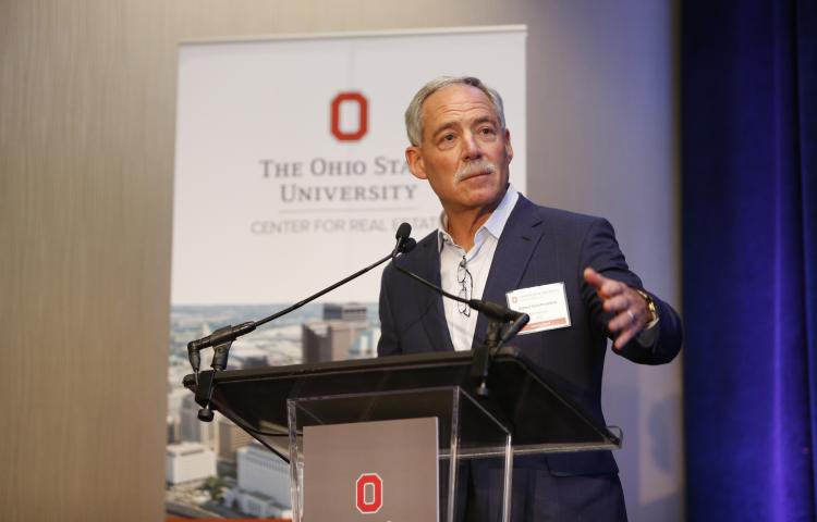 Bobby Schottenstein at podium speaks to MBA students