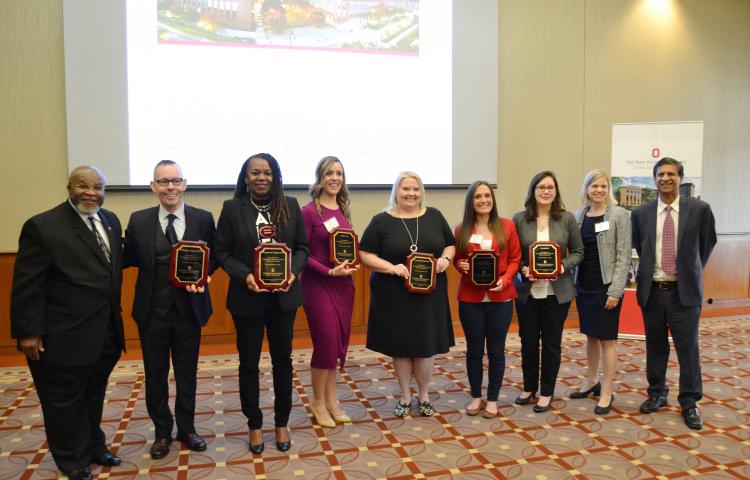 2019 Diversity Awards Nominees show off their awards in the front of the conference room
