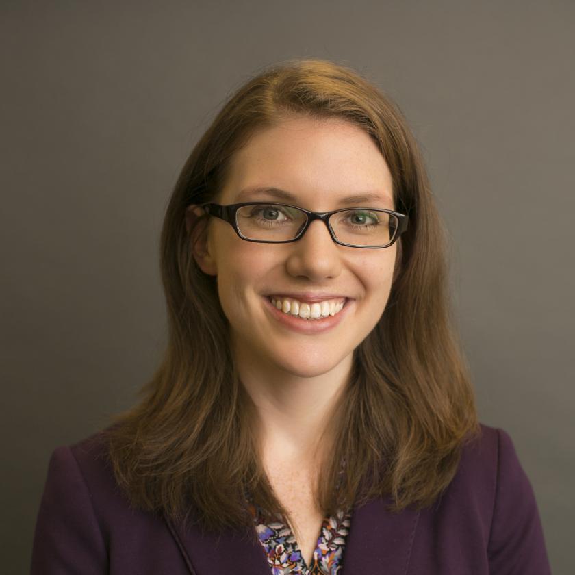 Kathleen Keeler wearing a purple coat and a styled dress shirt