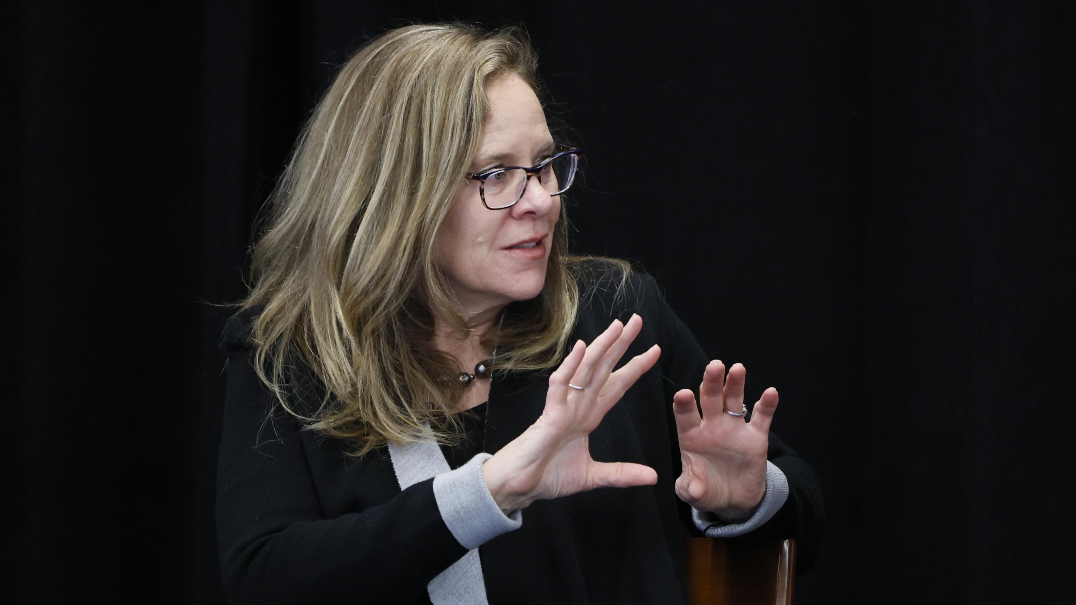 A woman speaks during a Risk event
