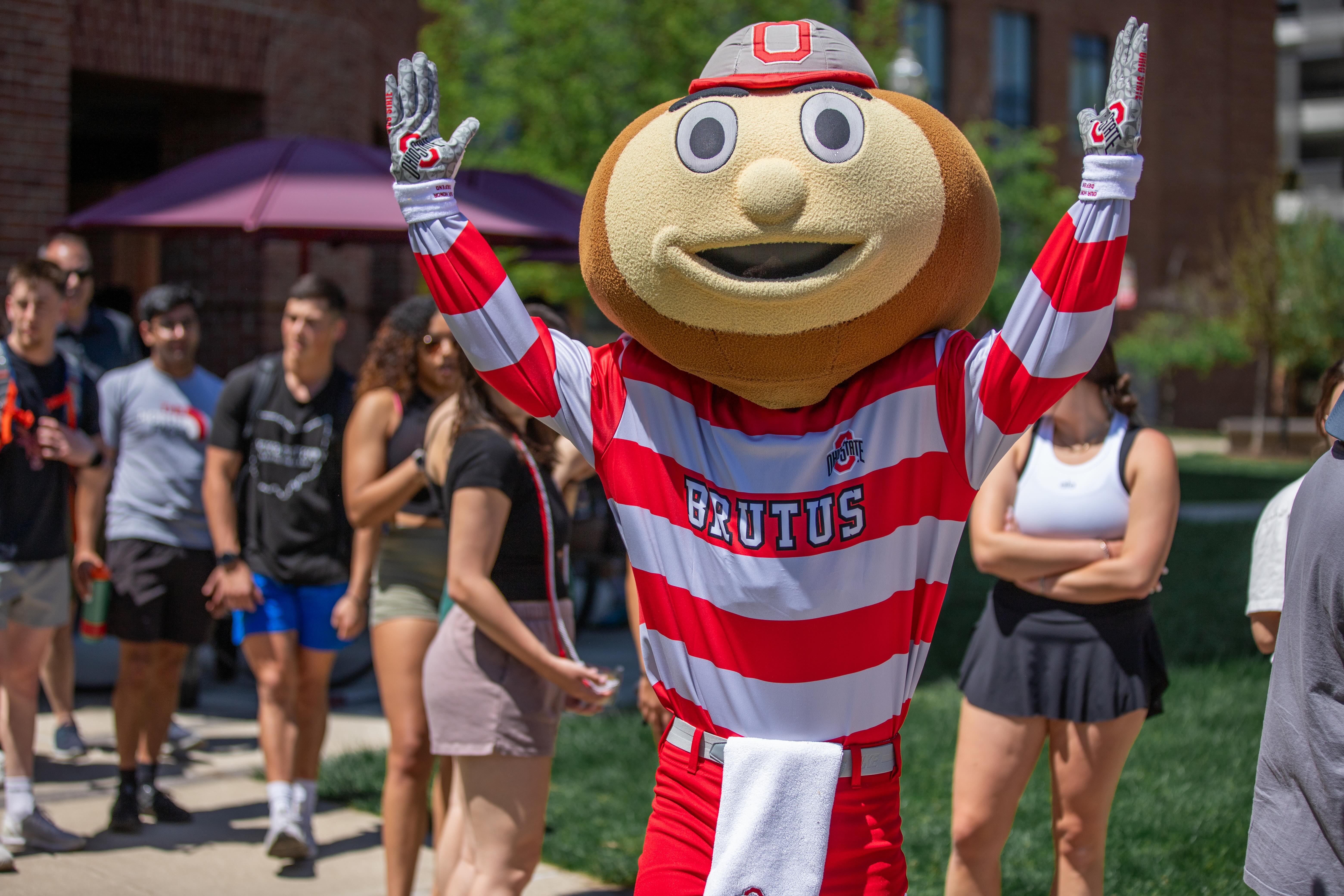 Brutus with arms raised up.
