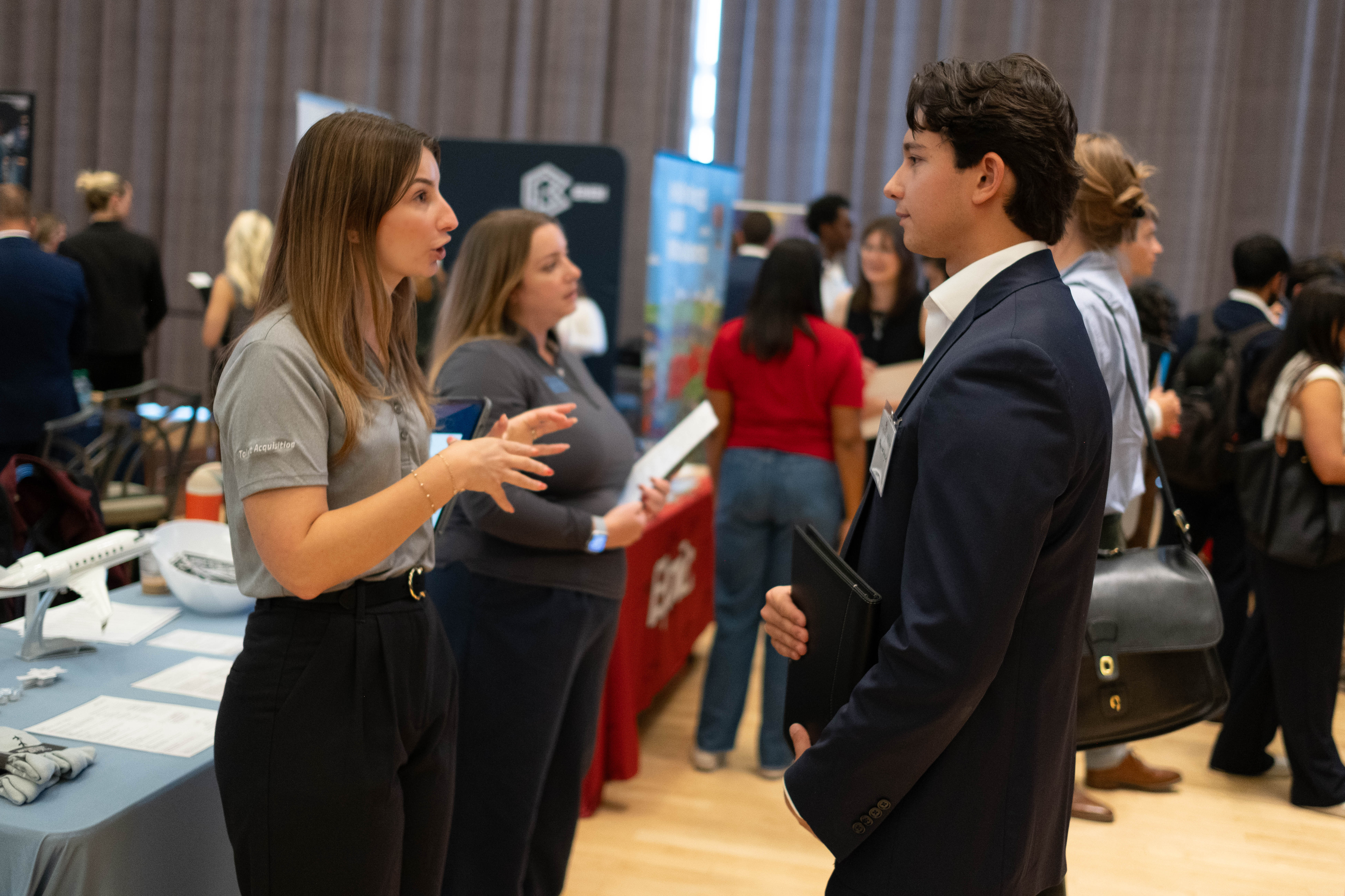 student speaking to a recruiter at a career fair