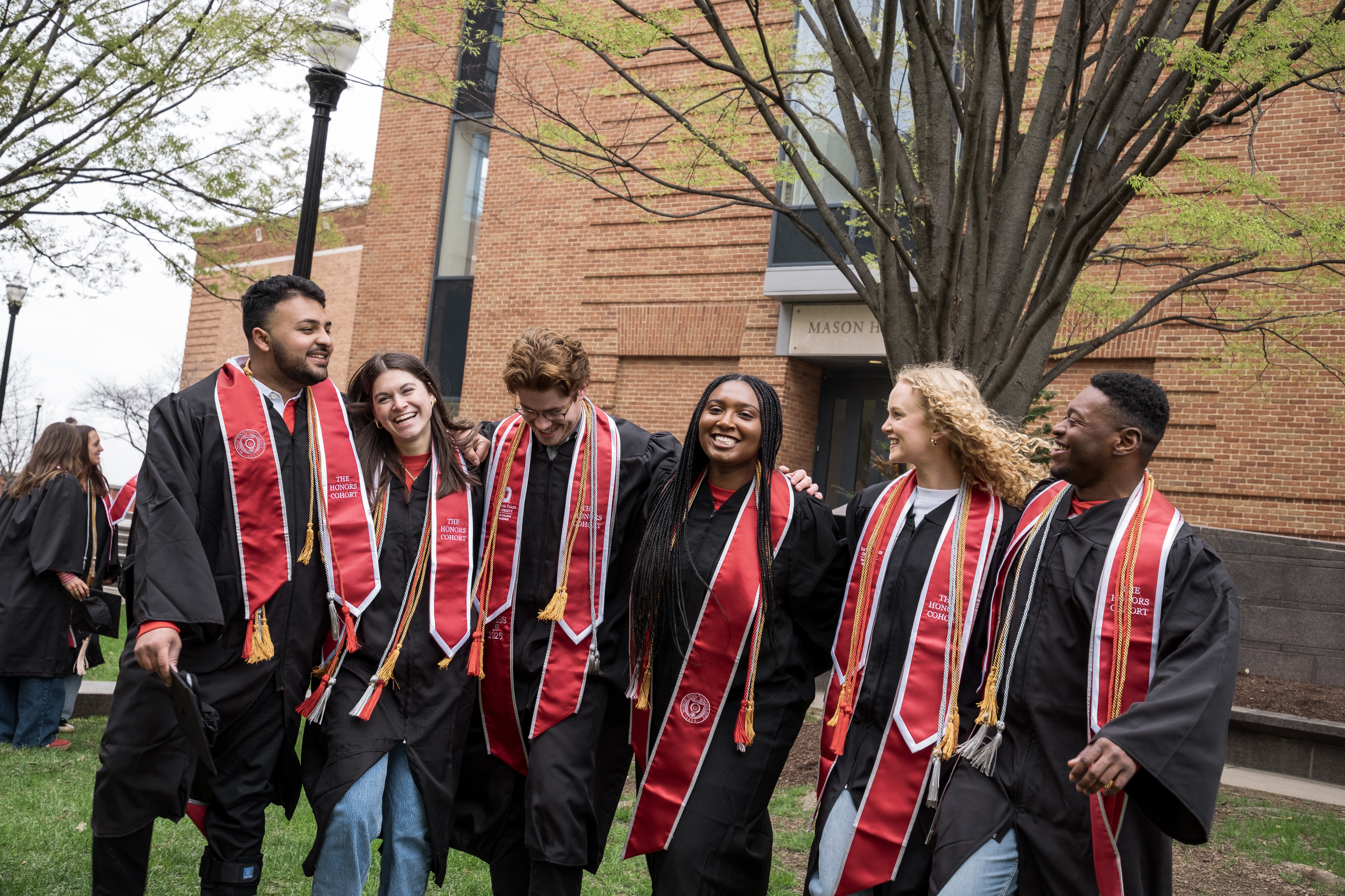 Students gathered together in graduation gowns.