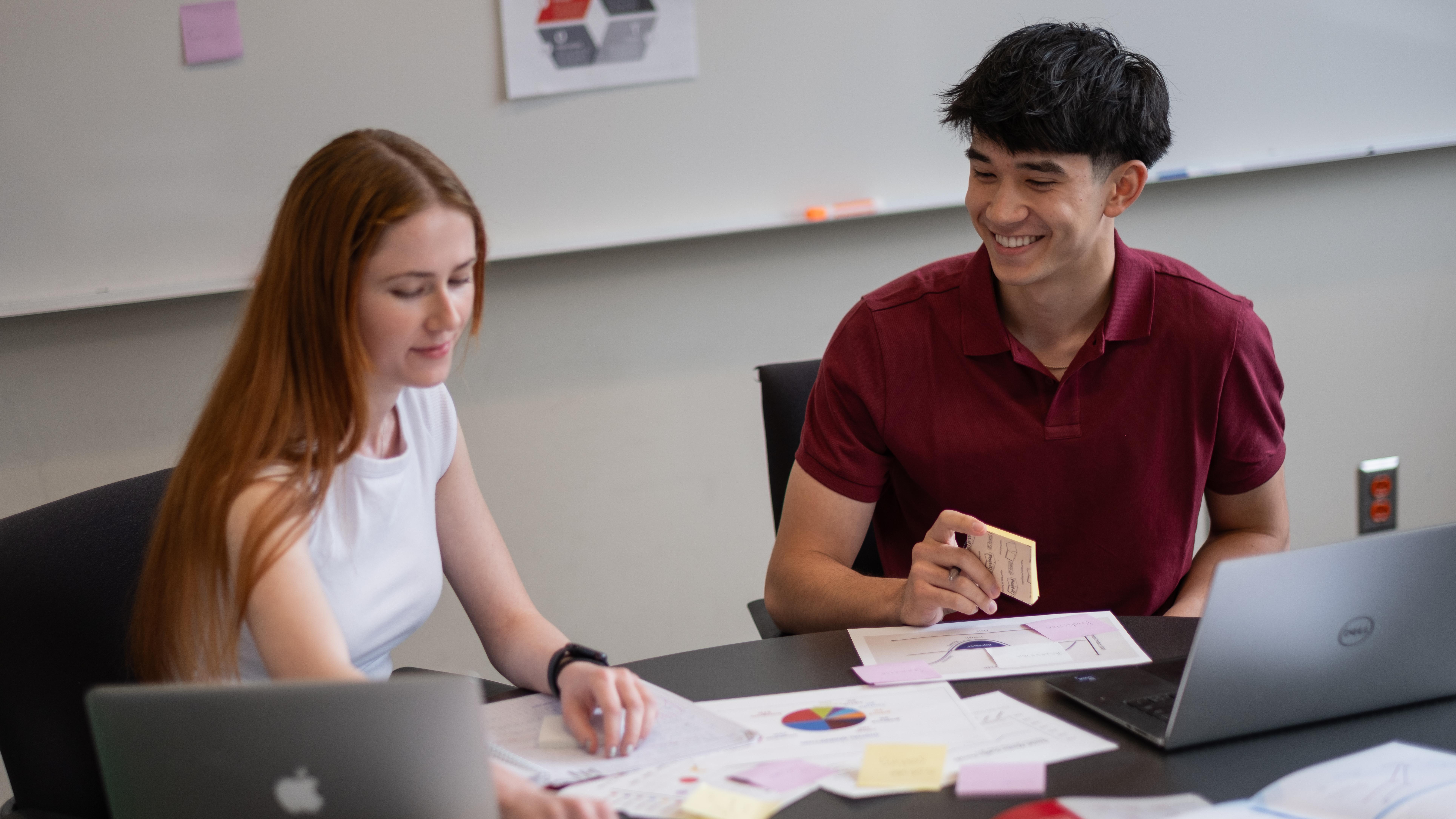 Two business students working together at a table