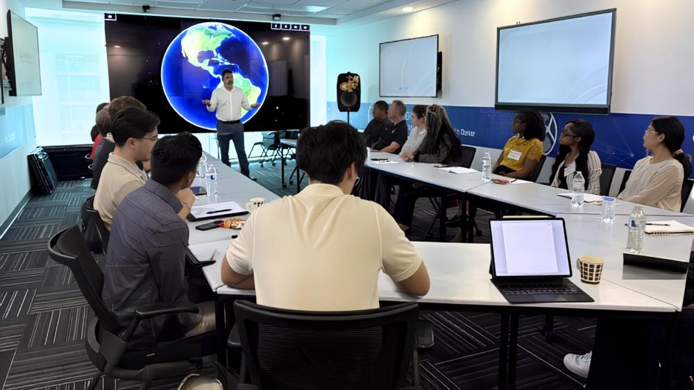 students in a meeting listening to a presenter