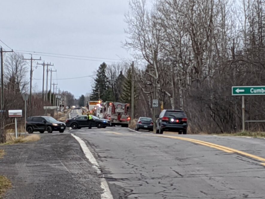 Firefighters and police near the scene of the fire, which broke out in a cabin off Russland Road on Tuesday. — photo Stephen Jeffery