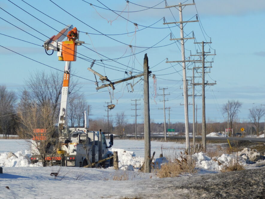 Hydro workers repair a damaged power pole Friday morning, located along County Road 17, about half a kilometer west of the Cassburn Road intersection in L’Orignal. — photo Gregg Chamberlain