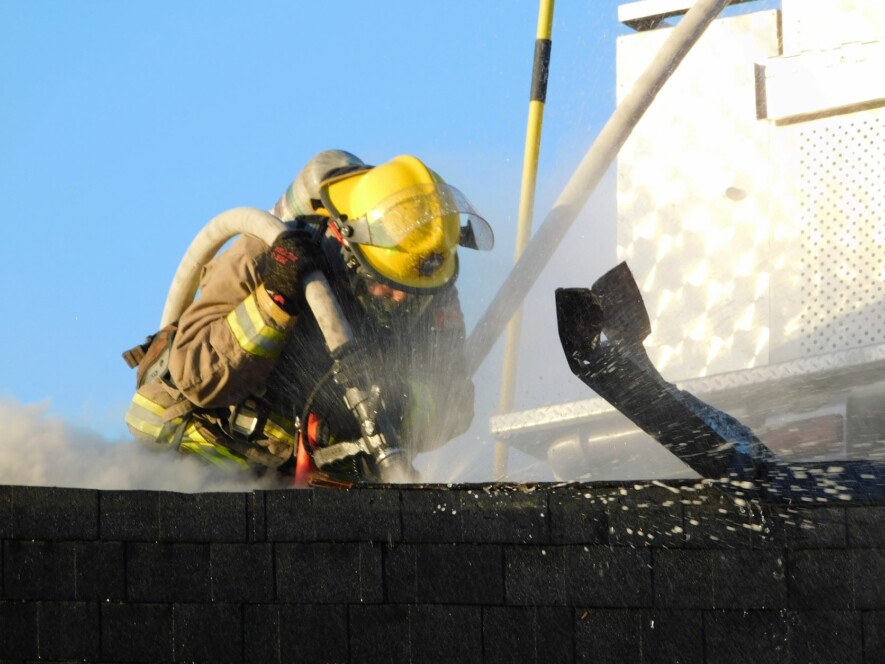 Firefighters broke through the roof of the building that once housed the Depanneur Jo’s grocery store to deal with any smouldering wood or other materials resulting from a February 14 fire that gutted the building. There were no injuries. Local fire department officials are now examining the site to determine the cause of the fire.  — photo Gregg Chamberlain
