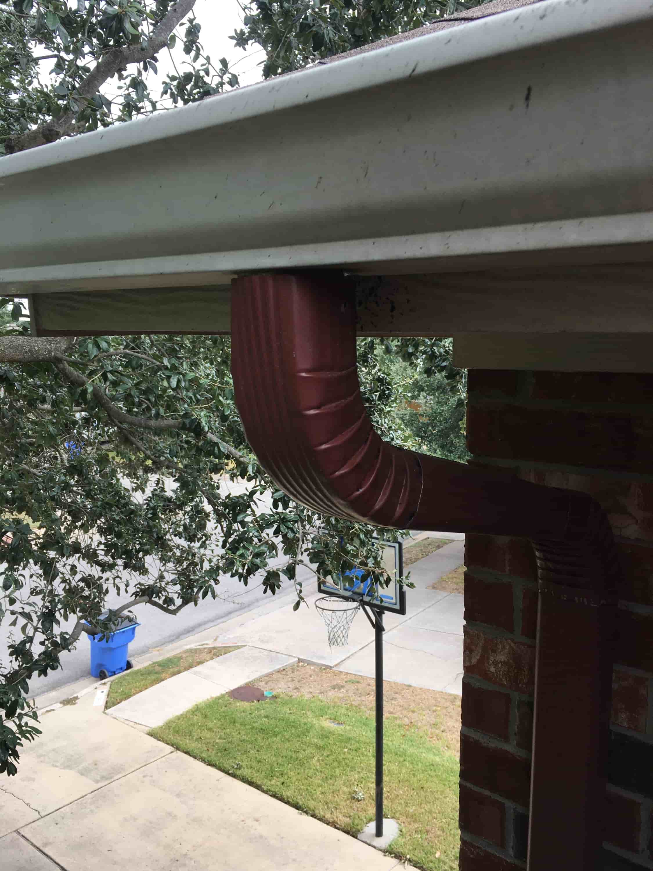 clean gutter downspout from ground