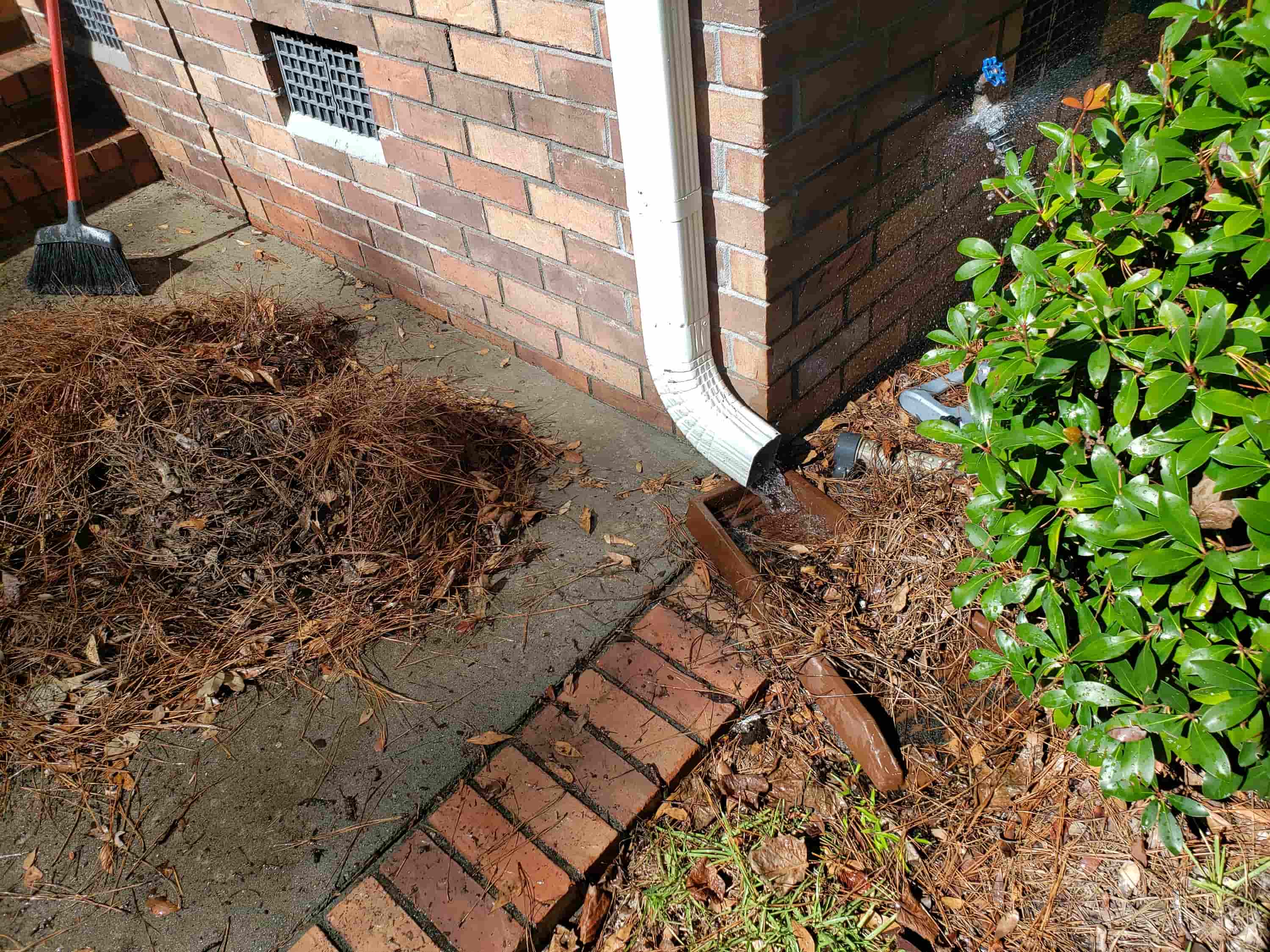 clean gutter downspout from ground