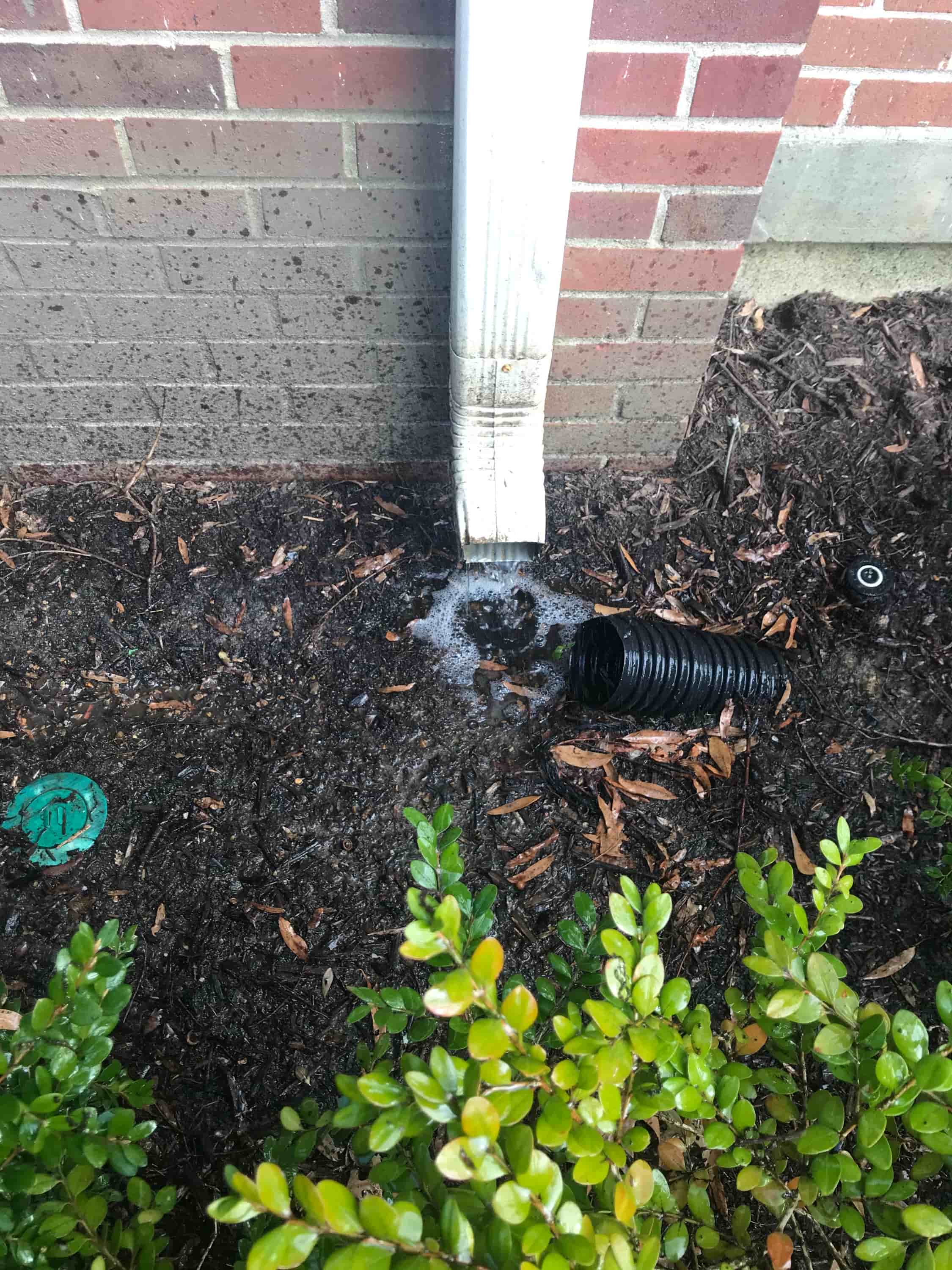 cleaning out gutter downspouts