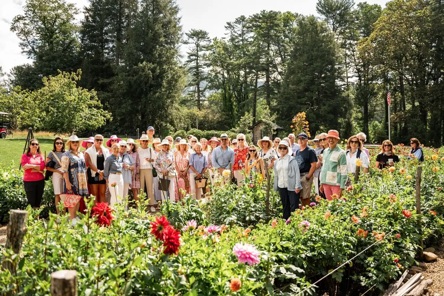 A large group smiling in High Hampton's Dahlia Garden