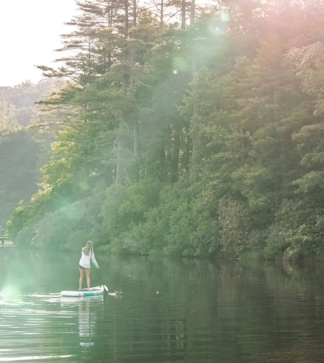 Young Woman Paddleboarding on Lake Hampton