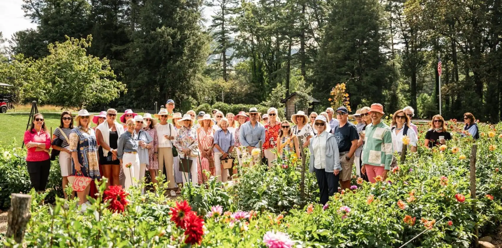 A large group smiling in High Hampton's Dahlia Garden
