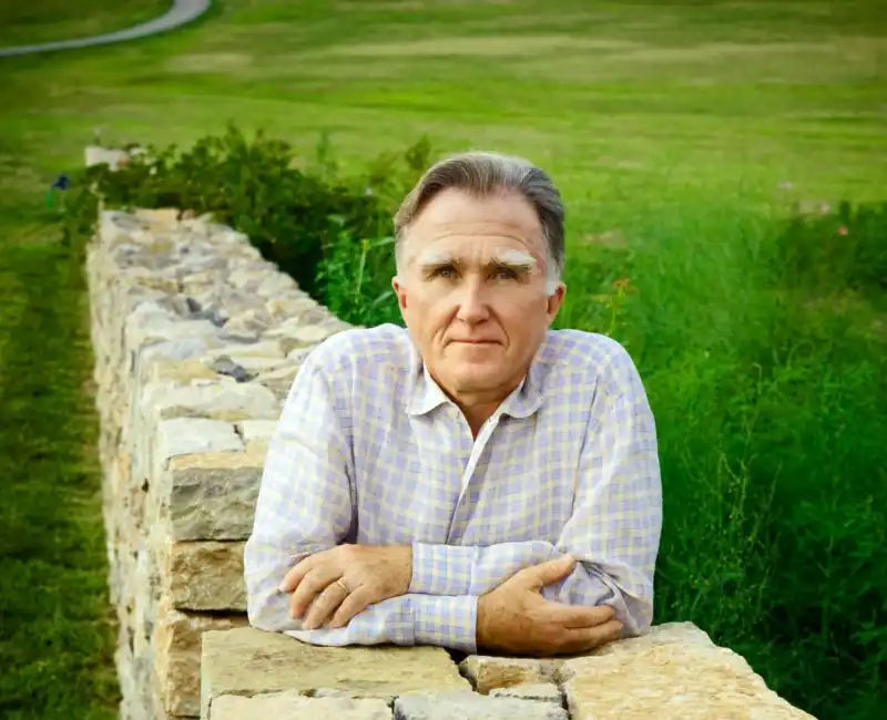 Ben Page Headshot on stone wall