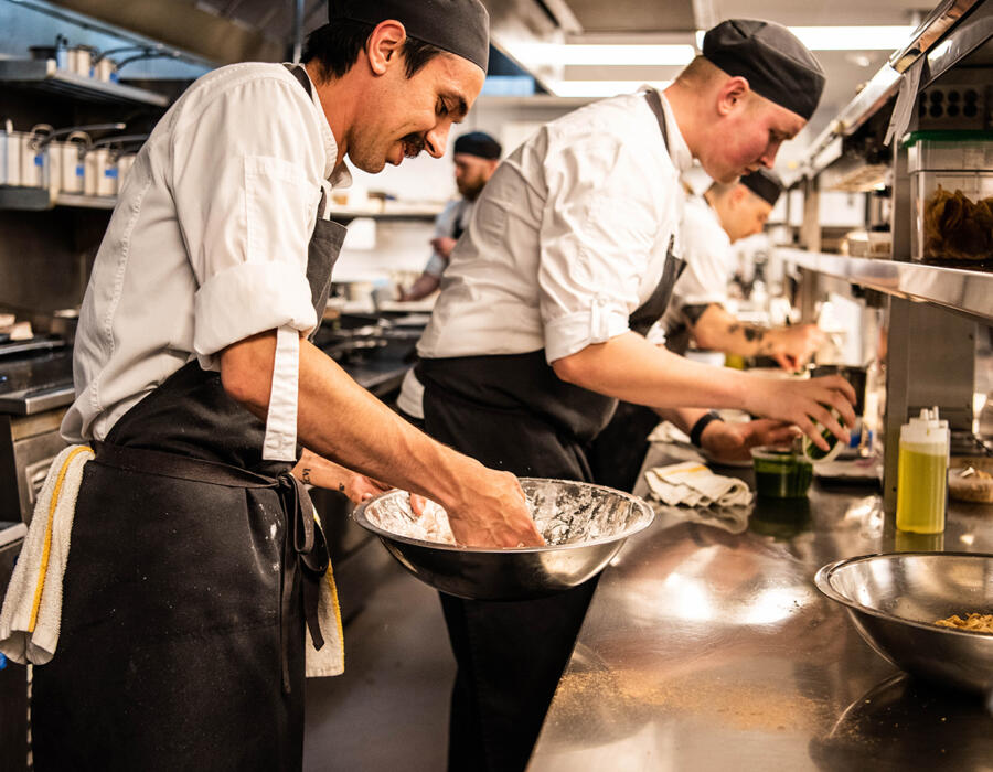 Line cooks preparing meals