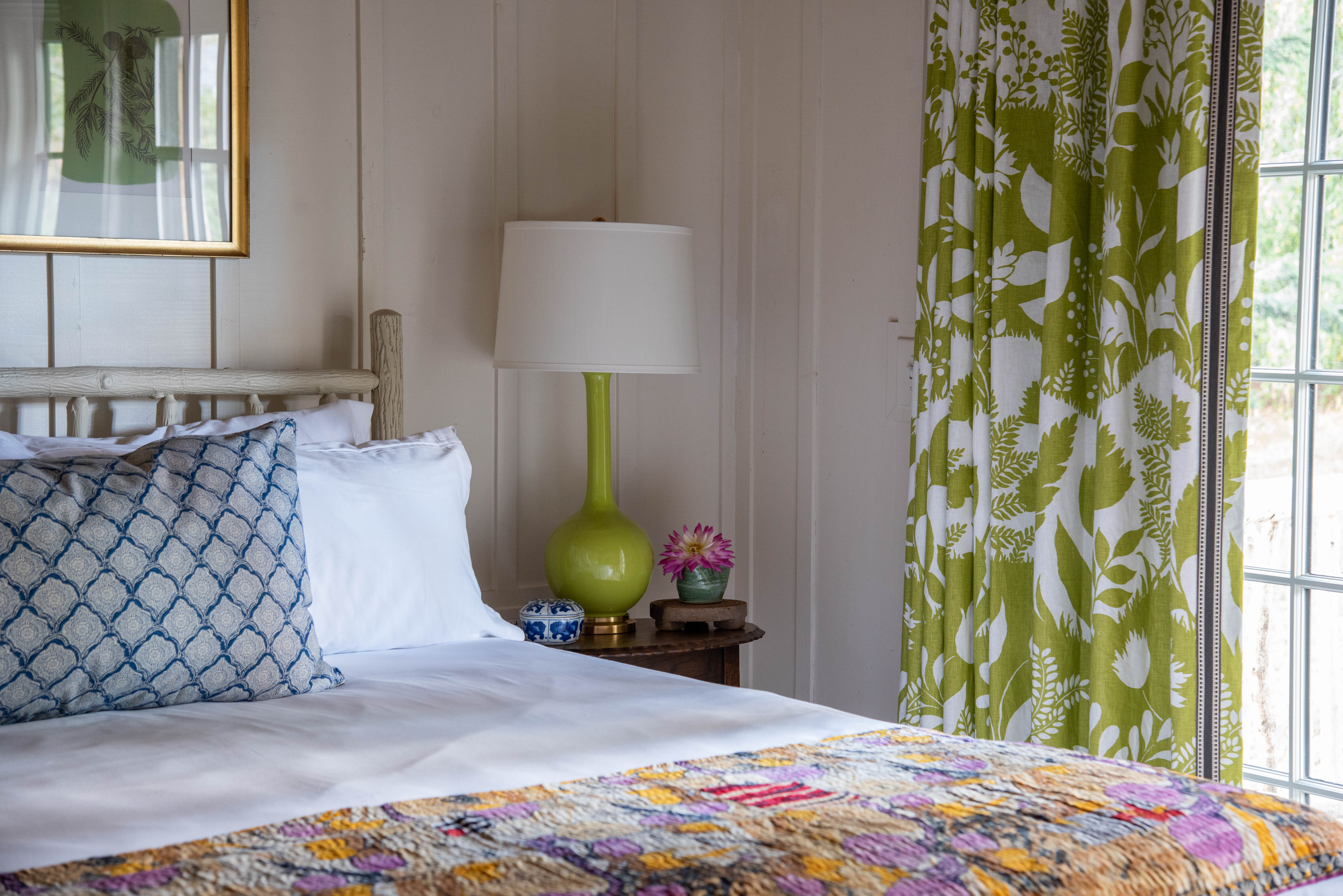A warmly lit bed and window