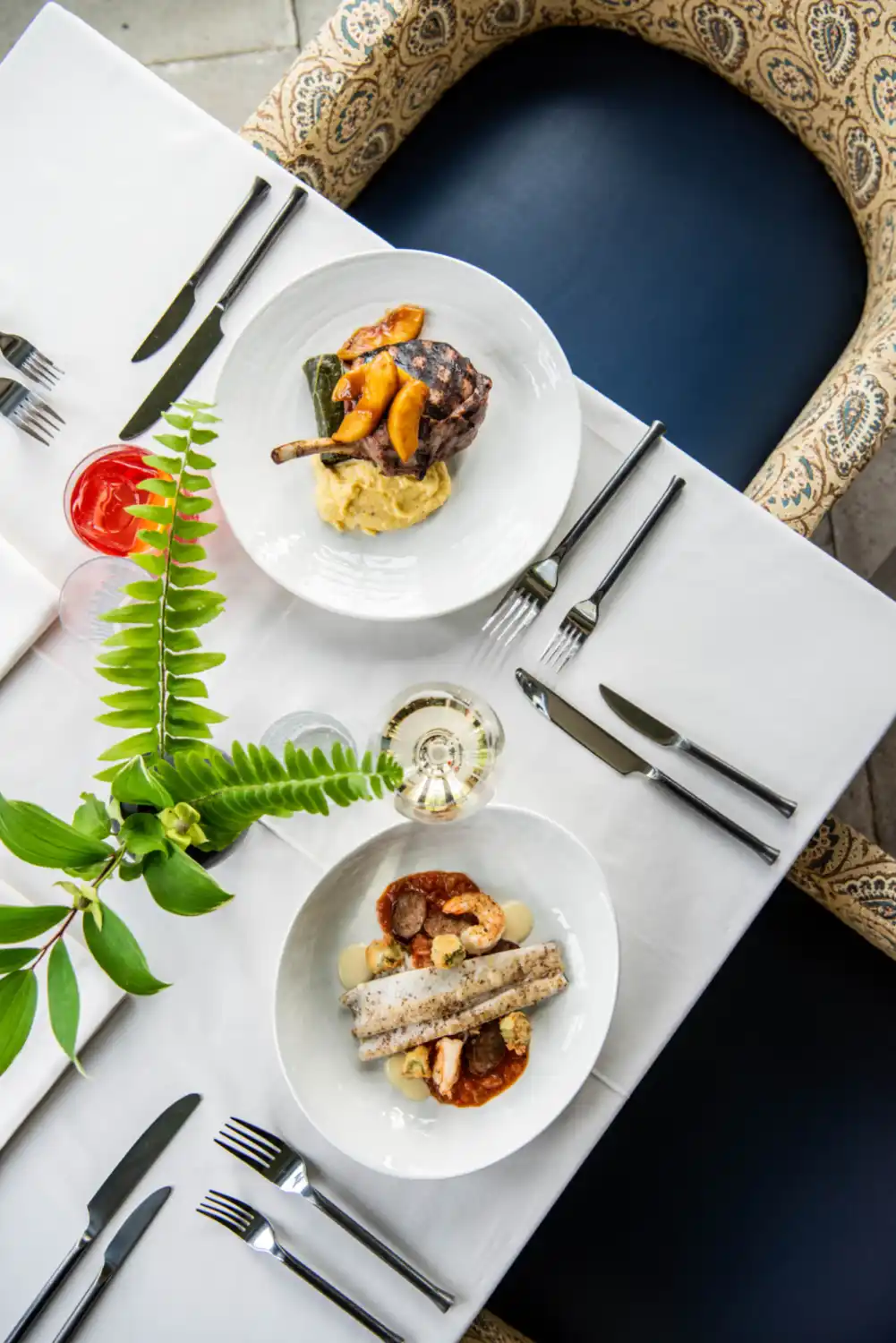 A table with two savory dinners and drinks