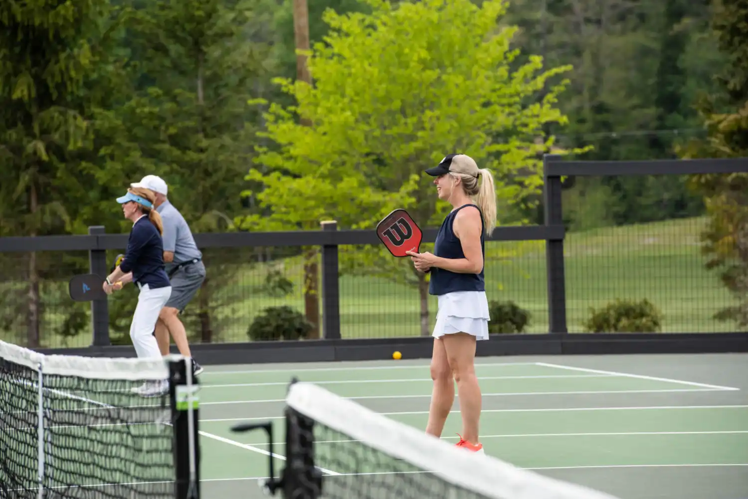People playing pickleball while smiling