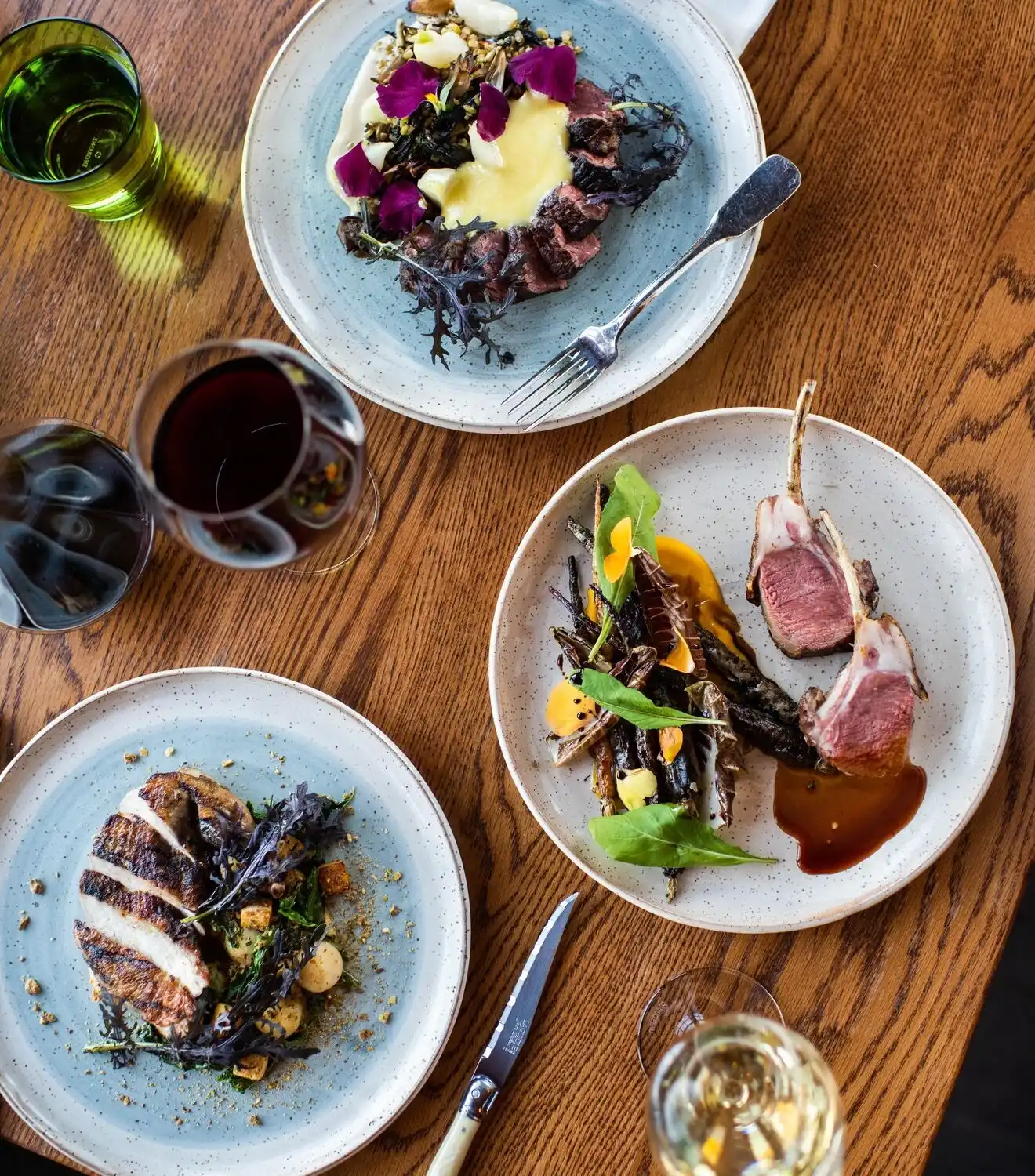 An overview of a savory meal with wine glasses