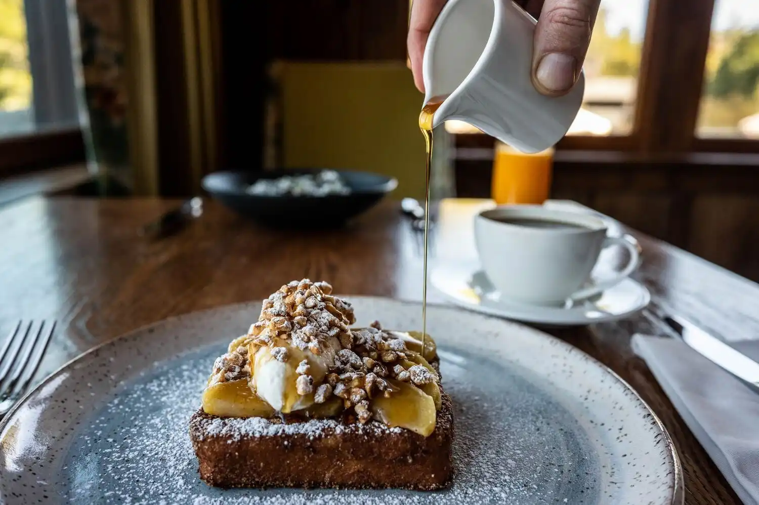 Syrup being poured onto delicious french toast