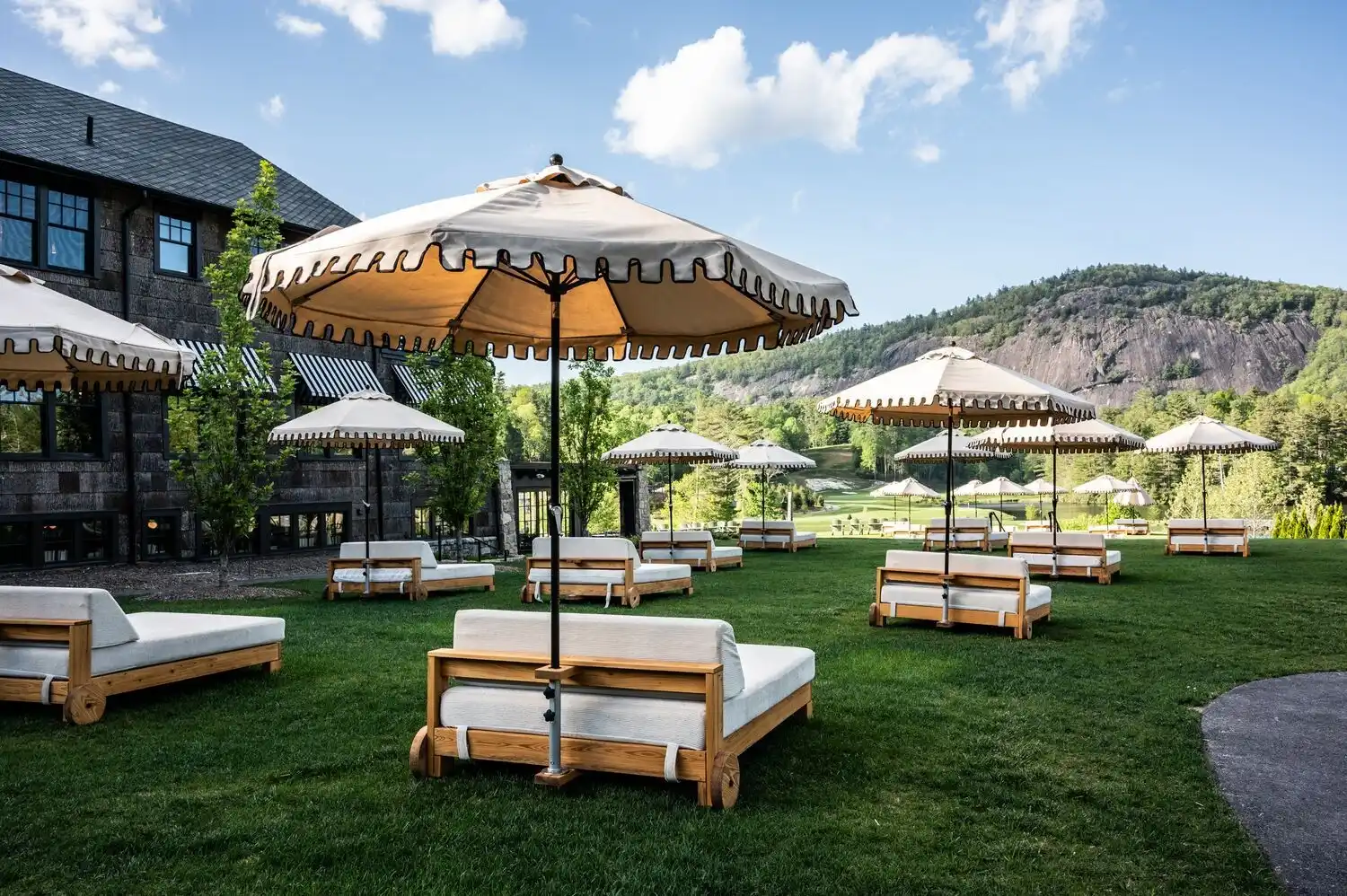 A lawn with daybeds and umbrellas