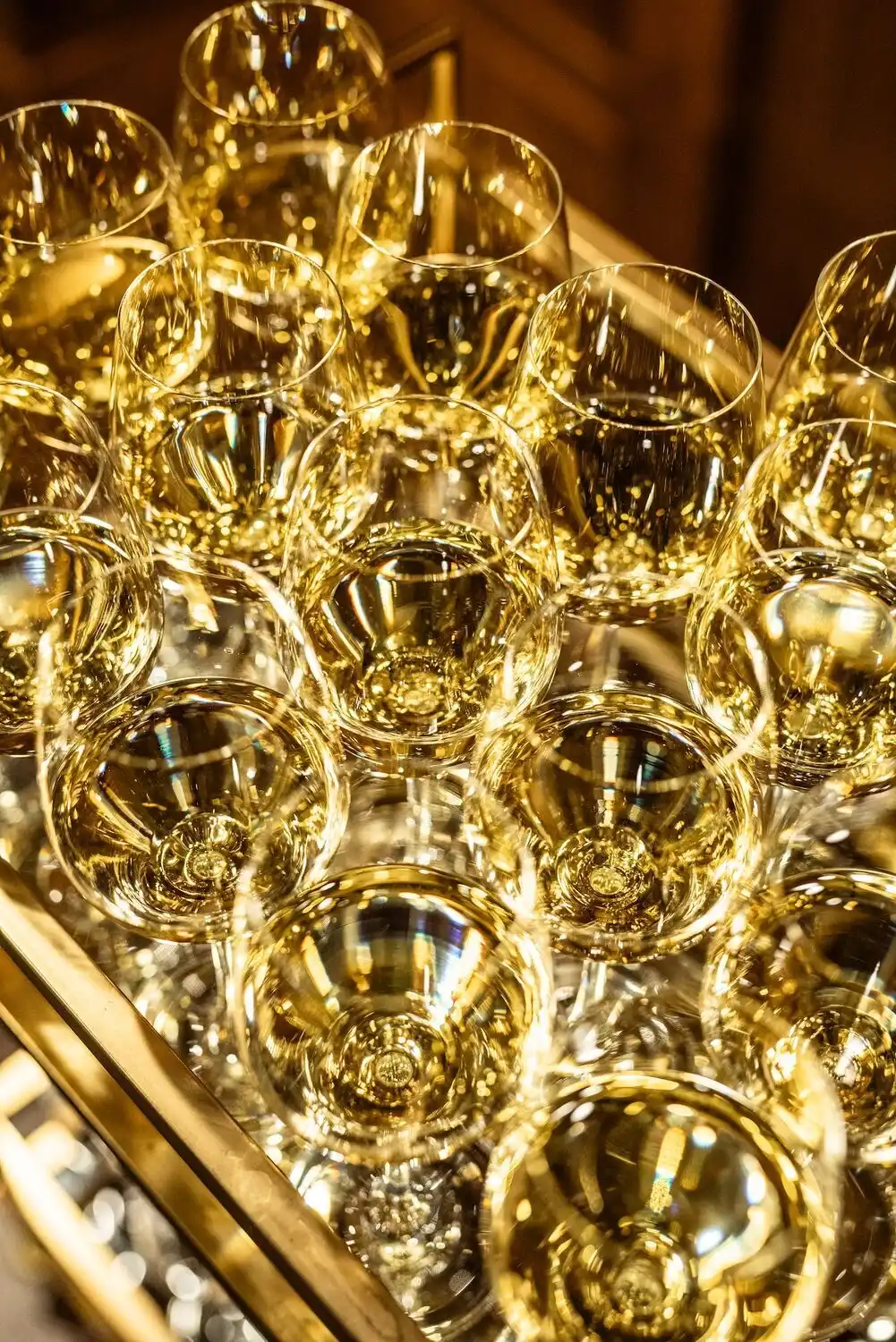 An up close shot of wine glasses glimmering with white wine