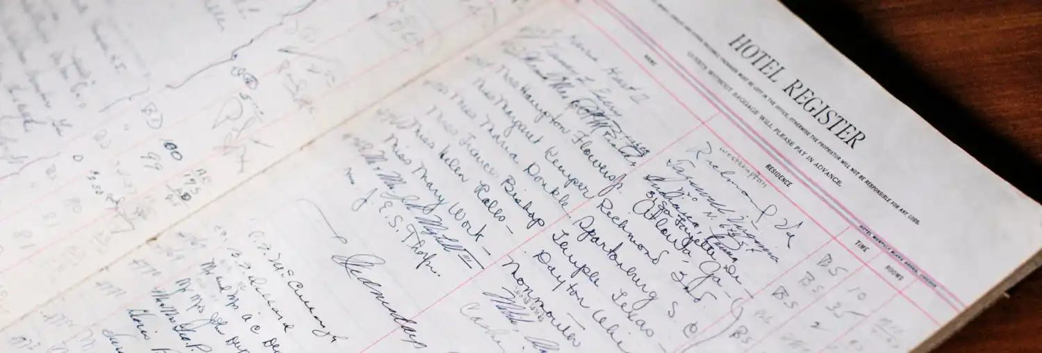 A historic guest book register listing names
