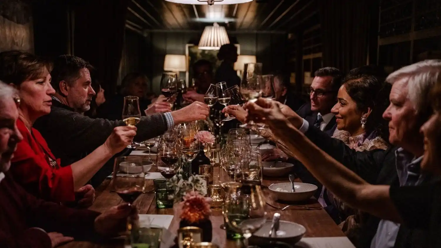People toasting in wine cellar