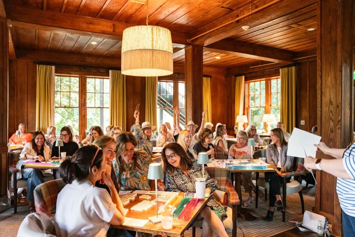 Large group of women smiling while playing Mah Jongg