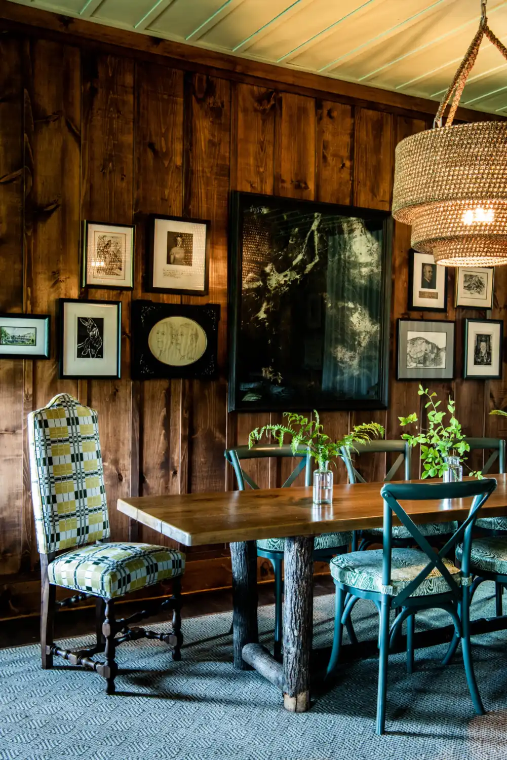 A gallery wall sits behind a dining table at Thorpe Cottage