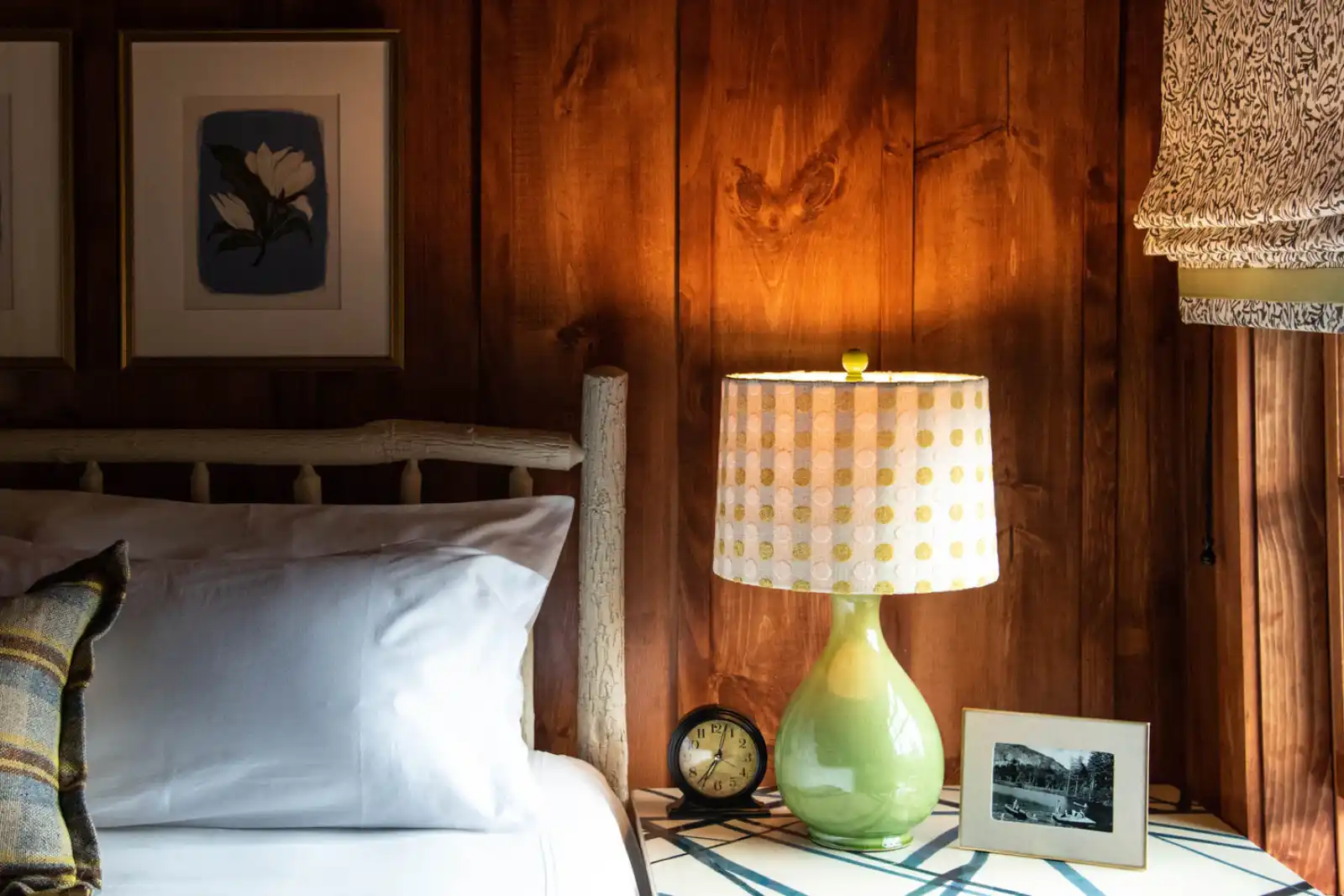 A close up of a bed with a lamp A close up of a bed with a lamp