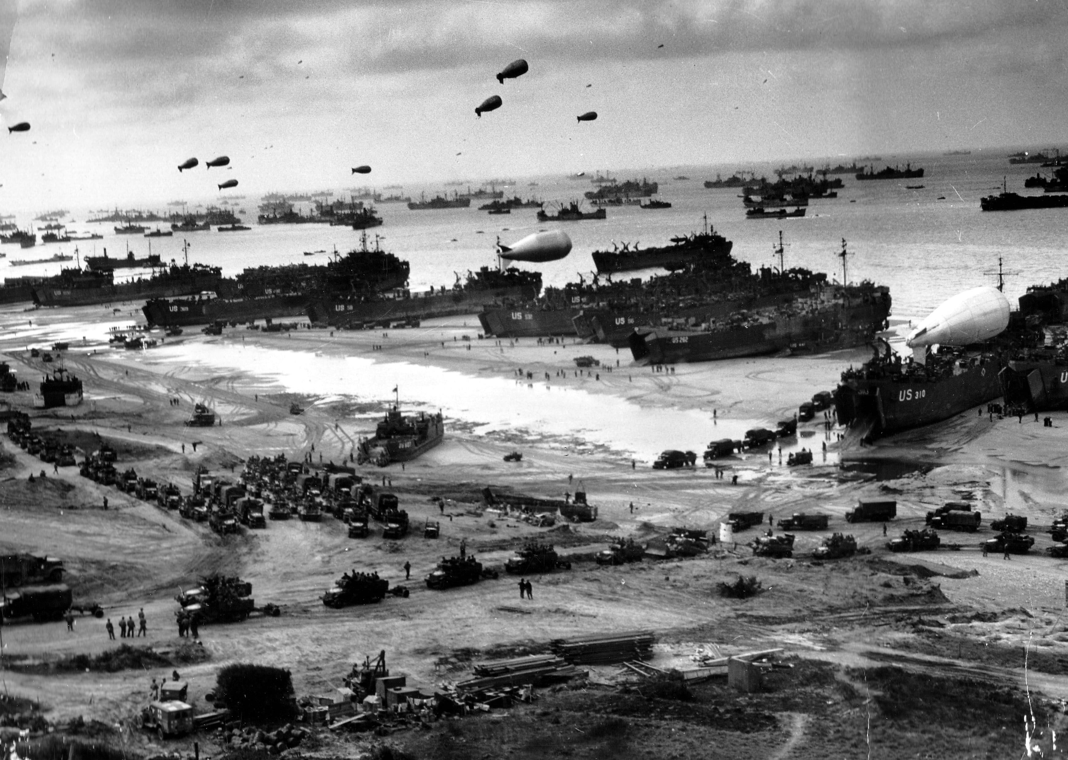 American troops land under heavy fire at Omaha Beach during the D-Day invasion.