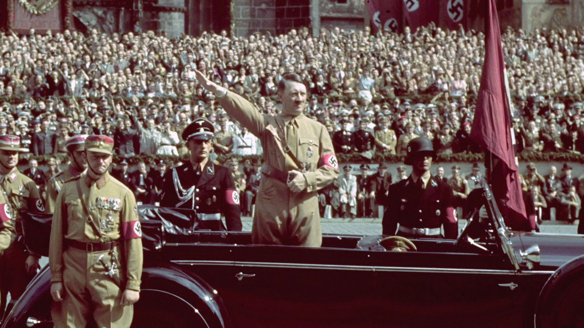 Adolf Hitler stands at a podium addressing the German Reichstag after being appointed chancellor.