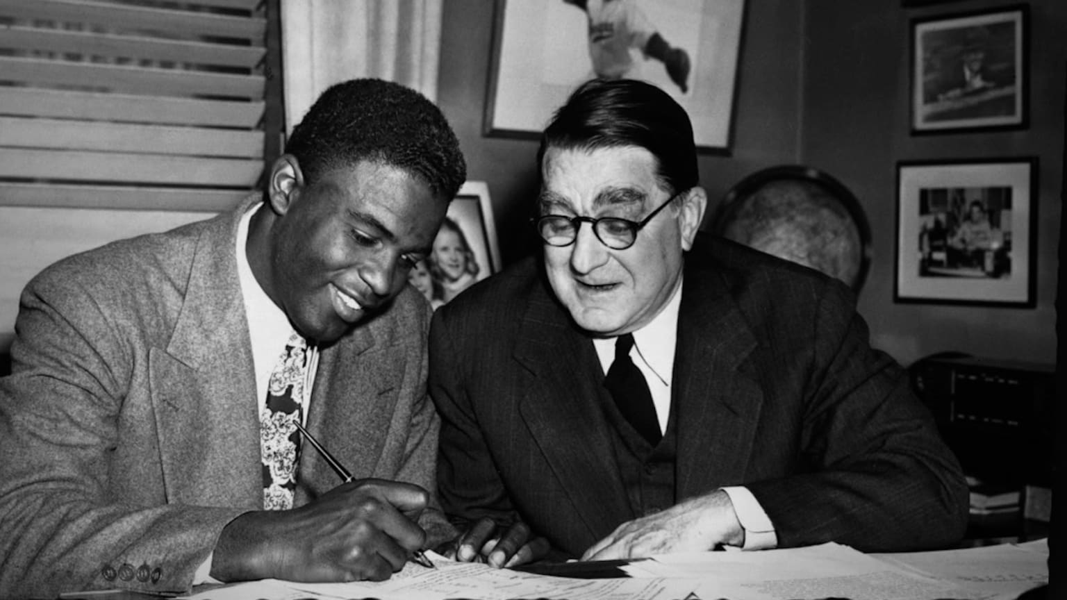 Jackie Robinson signs his major league contract with the Brooklyn Dodgers in 1947