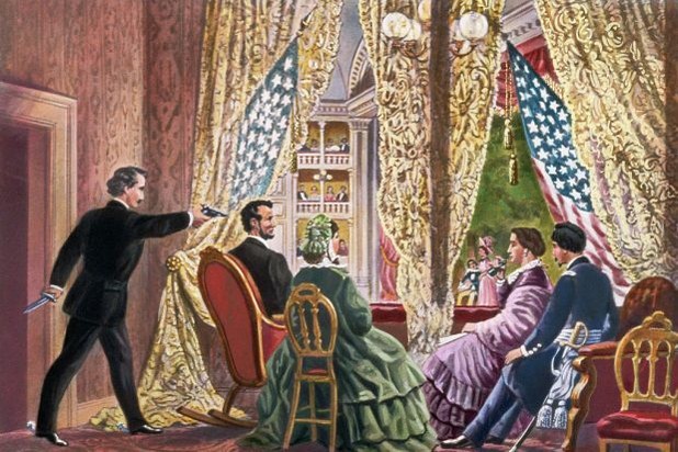 Abraham Lincoln’s box at Ford’s Theatre draped in flags with actors frozen in shock on stage