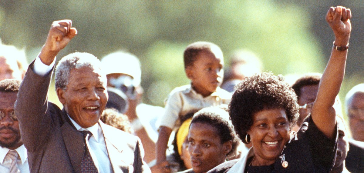 Nelson Mandela, hand in hand with Winnie Mandela, walks triumphantly out of Victor Verster Prison as crowds cheer.