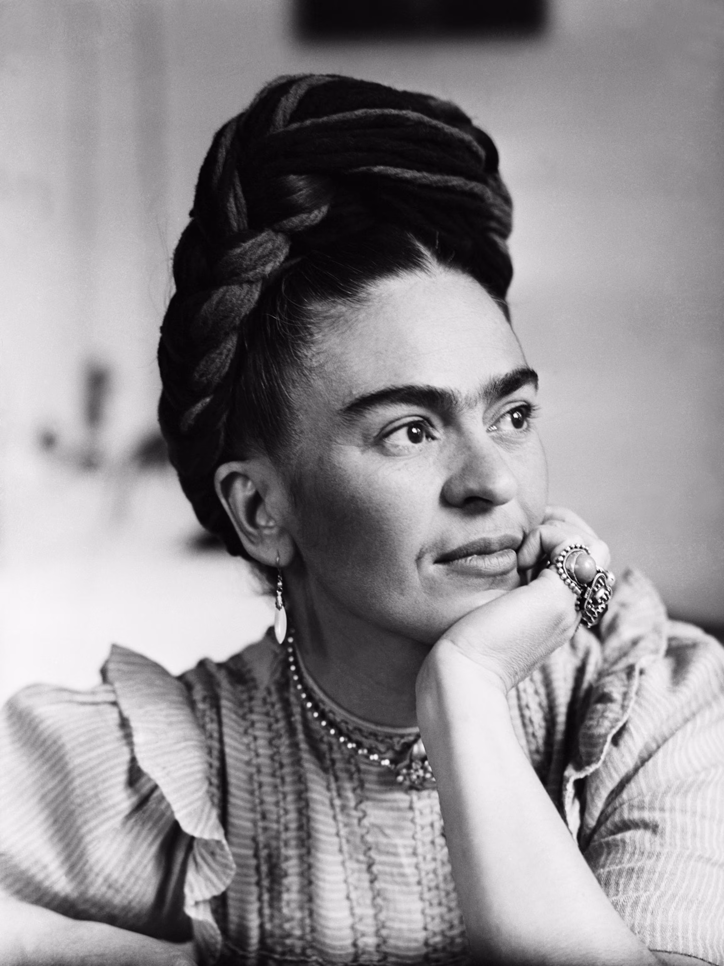 Frida Kahlo in traditional Tehuana dress, proudly blending her Mexican identity with personal symbolism.